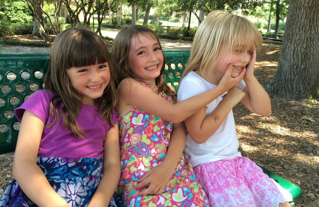 What's in a name? The twins last week, trying to get their cousin to smile with them for the camera.