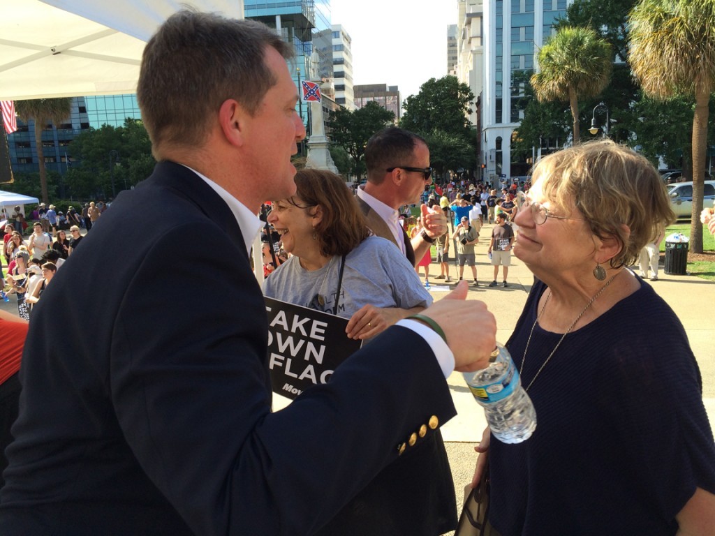 James Smith, shouting over the band in conversation with our own Lynn Teague at the second flag rally this summer.
