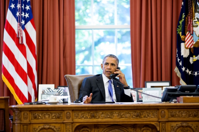 President Barack Obama talks on the phone in the Oval Office with South Carolina Gov. Nikki Haley to express sympathy for families affected by the floods and to offer whatever federal assistance is needed to help families recover, Oct. 5, 2015. (Official White House Photo by Pete Souza)