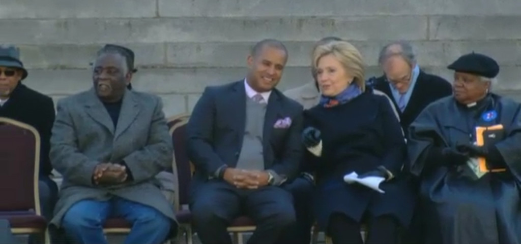 Hillary Clinton sitting on the COLD State House steps this morning with Todd Rutherford, awaiting her turn to speak.
