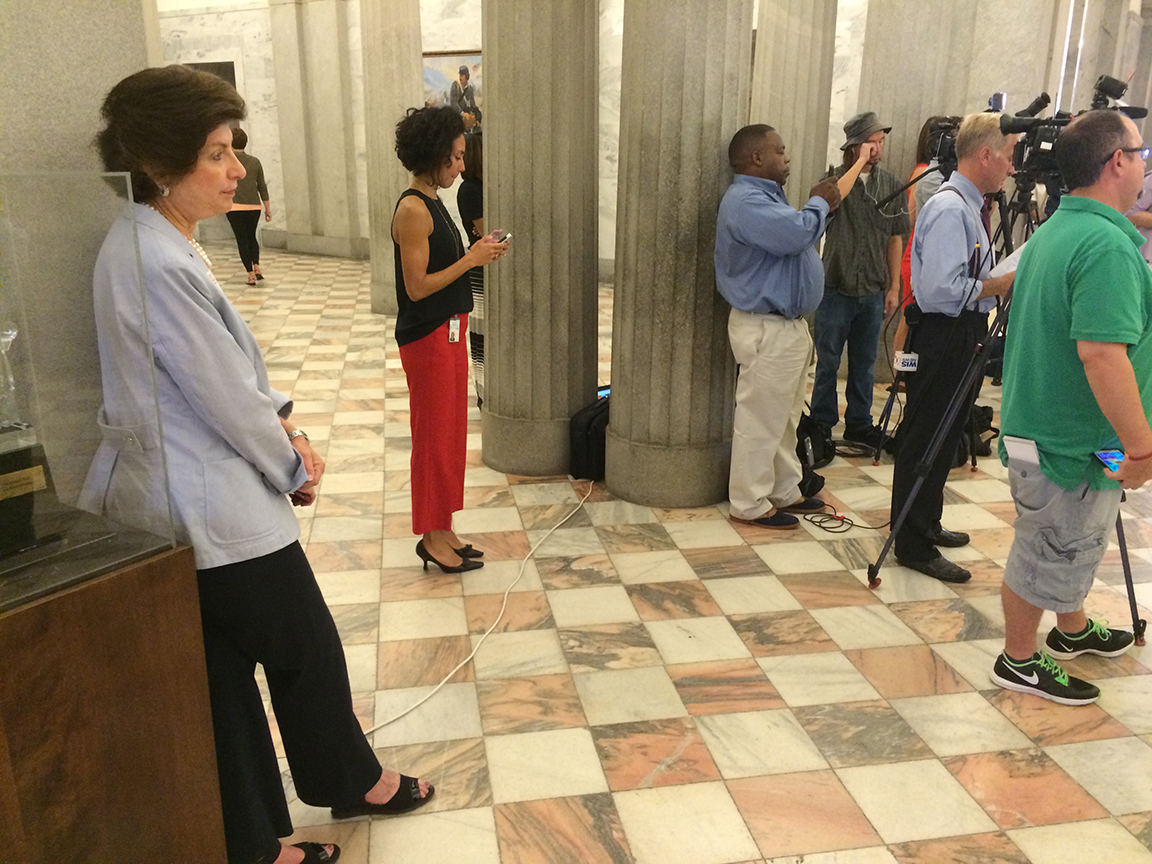 Susan Brill, Senate candidate, watches as members of the Richland County delegation call on RCRC members to resign.