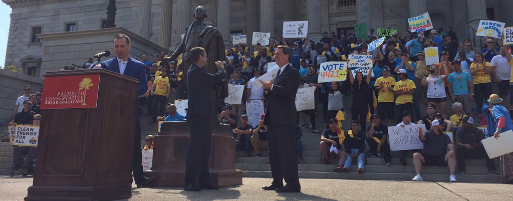 Matt Moore, Sen. Tom Davis and Rep. James Smith in front of the rally crowd.