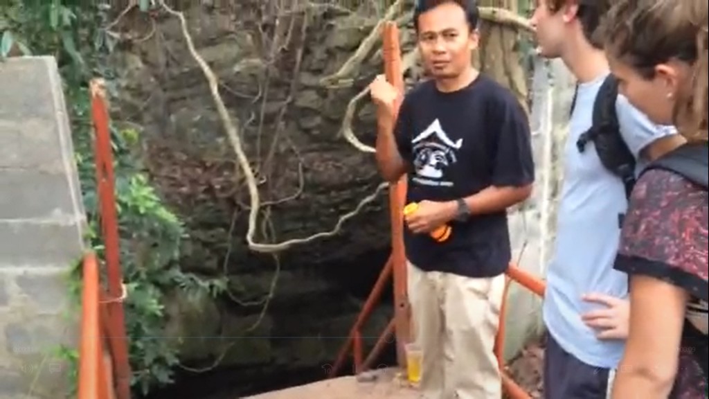 We explored a cave while we were in Thailand, too. Here, our guide gives us some pointers at the entrance as we prepare to climb down into it. I don't think I'll do that again...