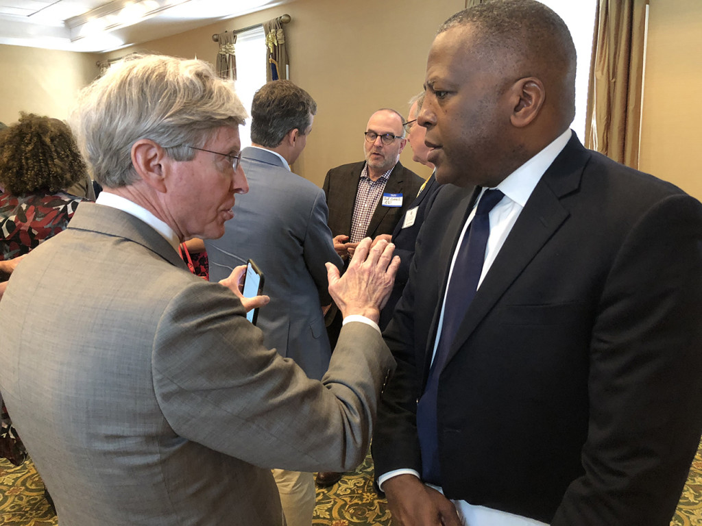 Local attorney Mitch Willoughby chats with the mayor after the forum.