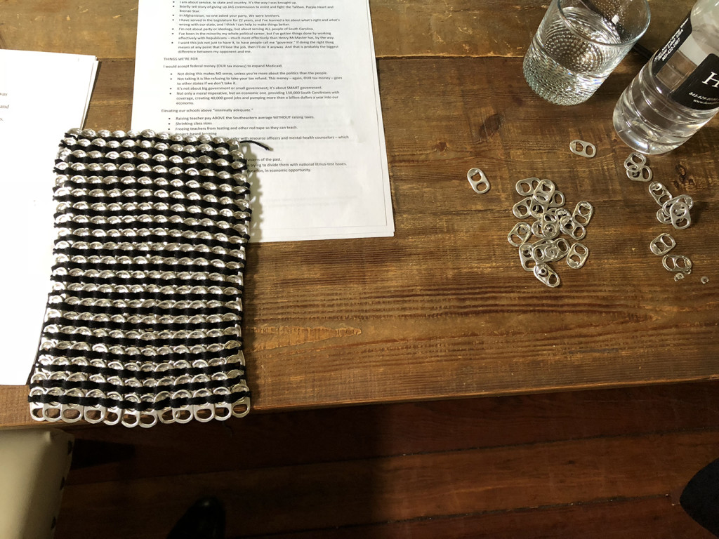 A completed part of the dress Kirkland was working on, sitting on the table in the hotel suite. At top you see a memo of talking points I had put together for the debate. Not that James needed it. He knew what his talking points were.