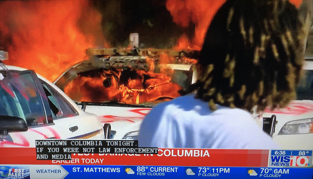 A police car burns in downtown Columbia.